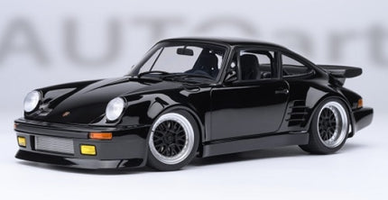 Black diecast model Porsche car 1:18 scale with yellow fog lights and detailed wheels