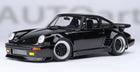 Black diecast model Porsche car 1:18 scale with yellow fog lights and detailed wheels