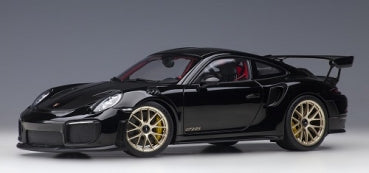 1:18 scale black Porsche diecast model car with gold rims and rear spoiler