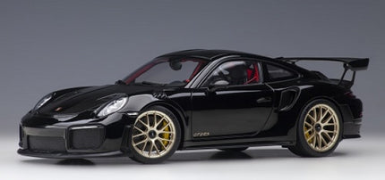 Black diecast Porsche GT2 RS 1:18 scale model car with gold wheels and rear spoiler