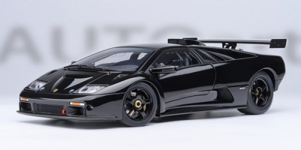 1:18 scale black diecast Lamborghini model car with rear wing on white background