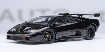 Black diecast model car in 1:18 scale with rear wing and detailed racing features