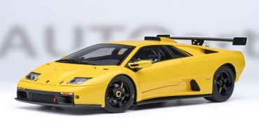 Yellow diecast model sports car with rear spoiler, 1:18 scale, detailed wheels and body
