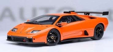 1:18 scale orange diecast model sports car with black accents and rear wing spoiler