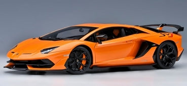 Orange diecast model sports car in 1:18 scale with black wheels and rear spoiler