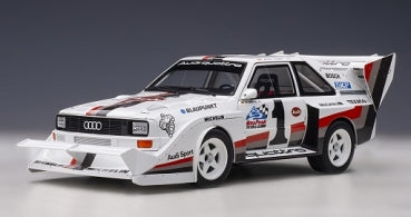 1:18 scale diecast Audi Quattro rally car model in white with racing decals and aerodynamic body kit