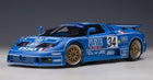Blue diecast model race car with number 34, Monte Carlo decals, gold wheels, 1:18 scale
