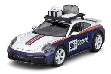 1:18 scale Porsche model car with racing livery, roof rack, and travel accessories