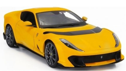 Yellow 1:18 scale diecast Ferrari model car with black accents on white background