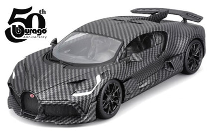 Diecast model car in carbon fiber finish with rear wing, 50th anniversary logo visible.