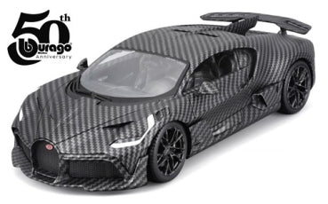 Diecast model car in carbon fiber finish with sporty details, 50th anniversary logo visible.