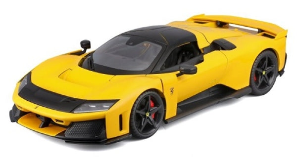 Yellow diecast Ferrari model car with black roof and detailed wheels in 1:18 scale