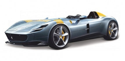 1:18 scale diecast model of a sleek grey open-top sports car with yellow accents.
