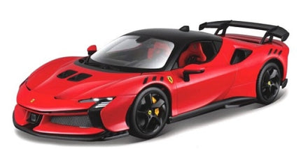 Red diecast Ferrari sports car model with black roof and rear wing on white background
