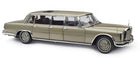 Diecast model car of a classic luxury limousine in metallic beige, 1:18 scale, detailed interior