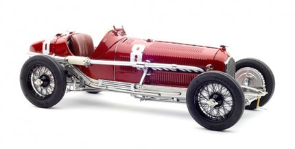 Red vintage diecast racing car model with number 8 and wire-spoke wheels, side view