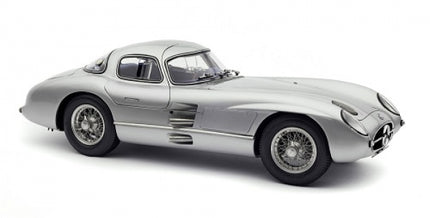 Silver diecast model car in 1:18 scale, classic coupe with detailed wheels and sleek design