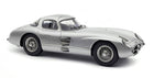 Silver diecast model car in 1:18 scale, classic coupe with detailed wheels and sleek design