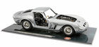 Silver diecast model car 1:18 scale with open door and hood on display base