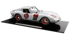 1:18 scale silver diecast model car with red racing decals displayed on black base