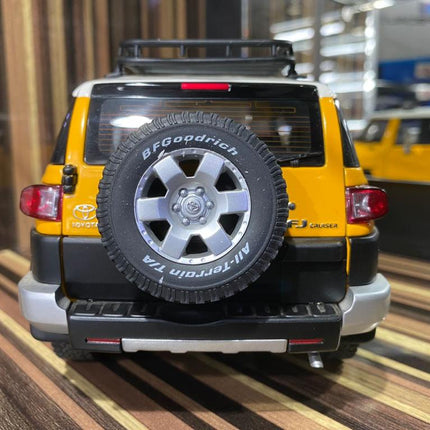 AutoArt Toyota FJ Cruiser Yellow 1:18 Diecast Model Car - studio product photo of the scale model