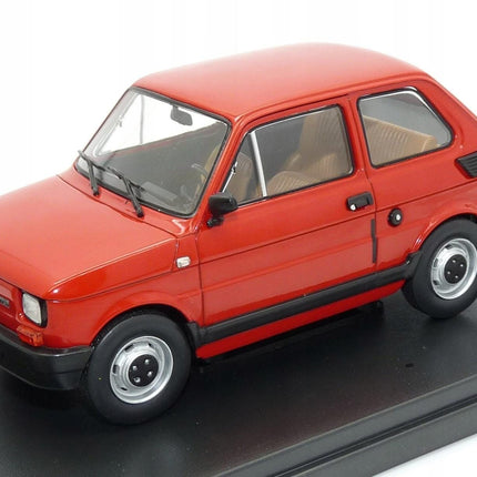 Front-left angled view of the 1:24 scale Fiat 126p diecast model in vibrant red displayed on a rectangular black base, highlighting the compact two-door hatchback shape with black plastic bumpers, round headlights, side windows and silver hubcap wheels.