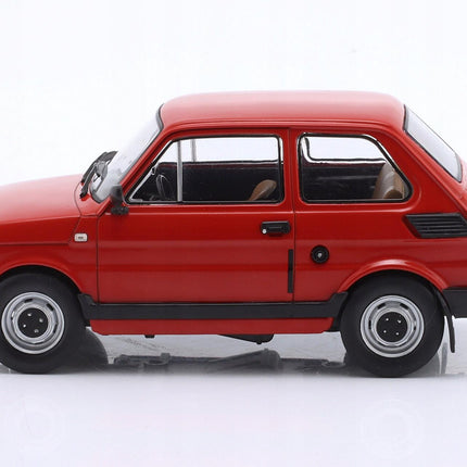 Driver-side profile view of a 1:24 scale 1985 Fiat 126p diecast model in bright red, showing the compact two-door hatchback body with a straight beltline, large side windows, black plastic bumpers, rear side vents, and silver hubcap wheels.