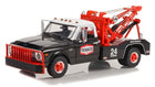 1:18 scale diecast model of black and red vintage tow truck with Texaco logo and 24 hour service graphics