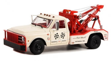 Diecast model vintage tow truck in white and red with race decals, 1:18 scale.