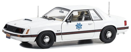 1:18 scale white diecast police car model with blue badge and black trim detailing