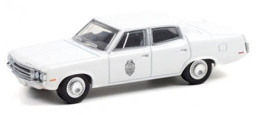 1:43 scale white diecast police car model with badge emblem, four-door sedan design