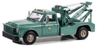 Green diecast model tow truck, 1:18 scale, detailed vintage design