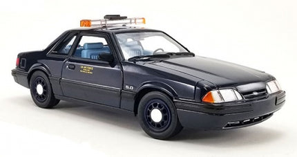 1:18 scale diecast black police car model with light bar, detailed interior, and classic design