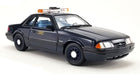 1:18 scale diecast black police car model with light bar, detailed interior, and classic design