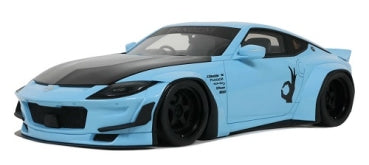 Light blue diecast model car with wide body kit, black accents, and racing decals