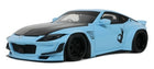 Light blue diecast model car with wide body kit, black accents, and racing decals