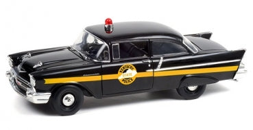 1:18 scale black diecast model car with police markings and roof siren