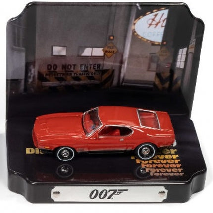 Red diecast model car in display case with 007 logo and garage background, collectible scale model.