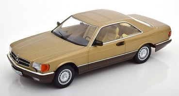 1:18 scale diecast model car, gold Mercedes coupe with detailed interior on white background