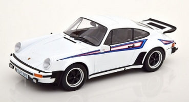 White 1:18 scale diecast Porsche model car with blue and red racing stripes, side view.