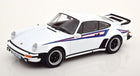 White diecast Porsche model car 1:18 scale with racing stripes and black wheels