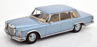 Light blue 1:18 scale diecast classic sedan model car with chrome trim on white background
