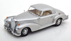 Silver classic diecast model car in 1:18 scale with vintage detailing