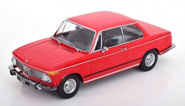 Red 1:18 scale diecast BMW model car with chrome detailing on white background