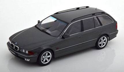 1:18 scale diecast model of a black BMW estate car with chrome trim on white background