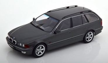 1:18 scale diecast BMW station wagon model car in dark gray with silver trim on white background