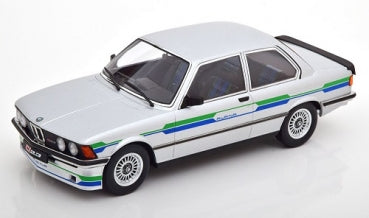 1:18 scale diecast BMW model car in white with blue and green stripes, side view