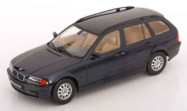 1:18 scale dark blue BMW station wagon diecast model car with tan interior on white background