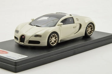 White diecast model car on display stand, luxury sports car in 1:18 scale.