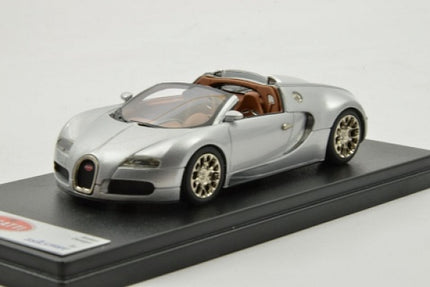 Silver diecast model sports car convertible on display base, 1:18 scale collectible